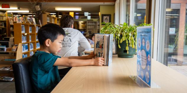 Boy Reading a book at the Smithers Public Library